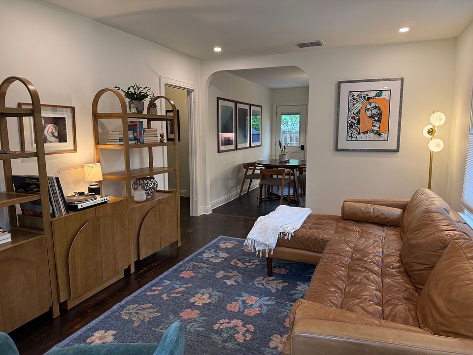 Thoughtfully furnished living room leading to newly remodeled kitchen.