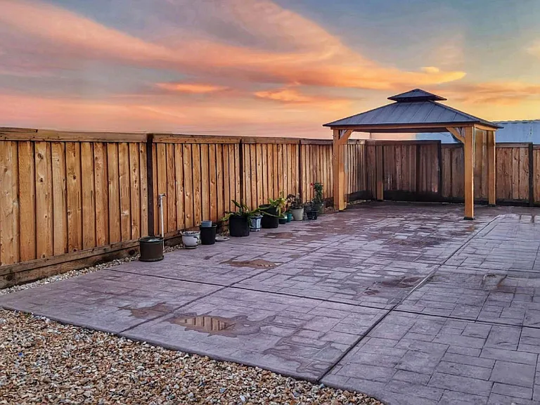 Completed landscape with low maintenance, cement covers the front, side, and back yard.