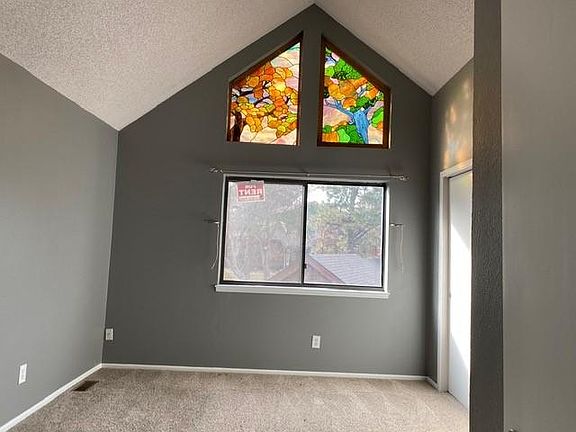 Master bedroom with stained glass window.