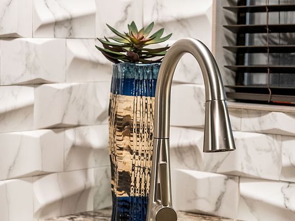 Corner undermount sink by sunny window.