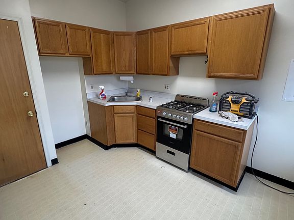 Kitchen, new stove & New Refreigator door to the left, hallway to the building.