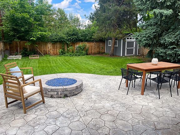 Back yard large stone patio, fire pit and storage shed