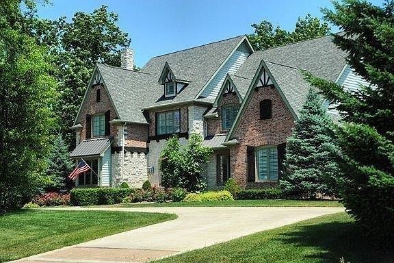 A circular heated drive welcomes you and your guests to this stately home residing on a wooded 1 acre site. Architecturally correct finishing touches include steel accents, and rough sawn cedar shutters and beams stained in a warm Chestnut finish. Kolbe a