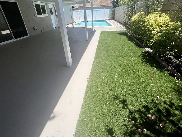 Large patio and artificial turf areas