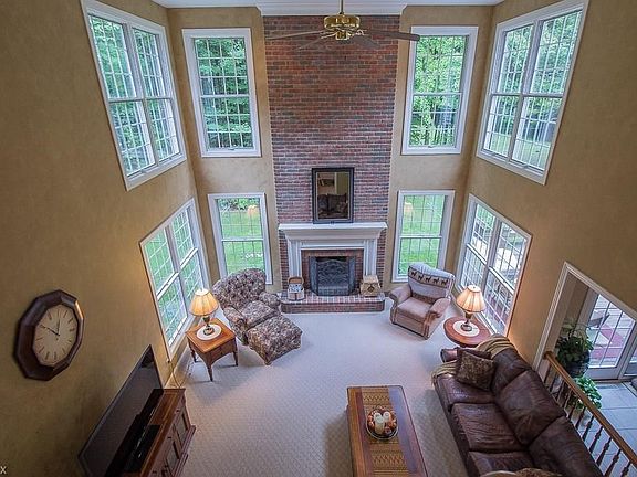 The 2nd Floor balcony walkway overlooks the two story Great Room showing off the beautiful back yard.