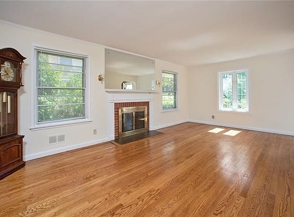 Living room with fireplace with beautiful hardwood floors