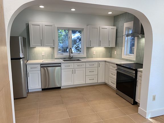 Newly remodeled kitchen with new induction range, fridge, and dishwasher.