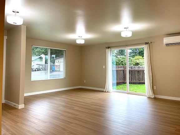 Spacious great room with patio to large fenced yard.