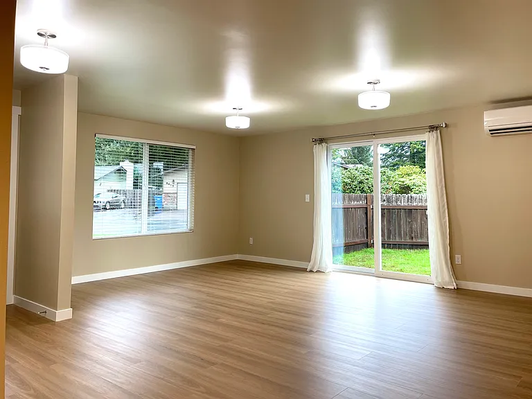 Spacious great room with patio to large fenced yard.