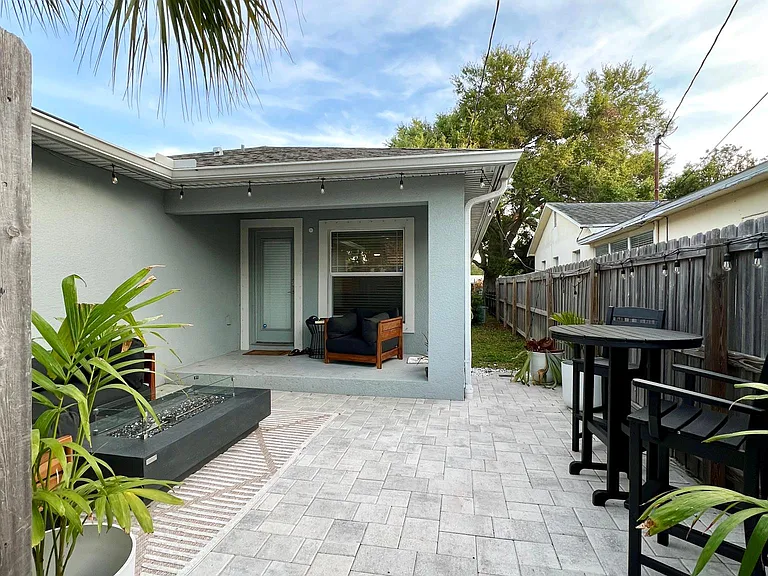 Gated exterior patio with firetable, dining and seating