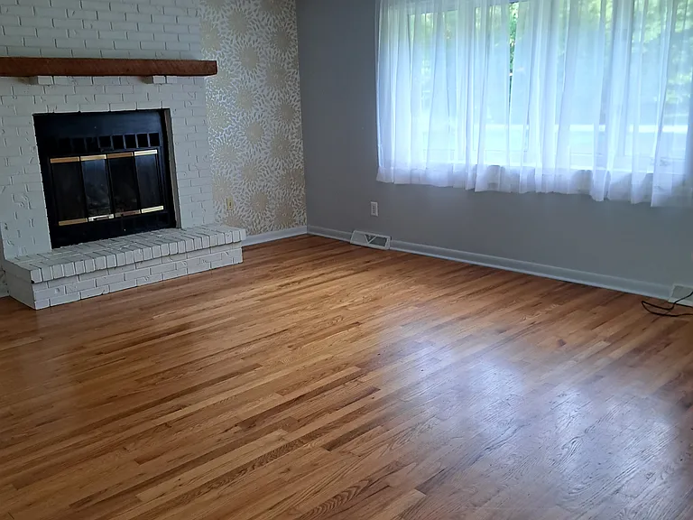 Living Room with natural hardwood floors and gas log fireplace.