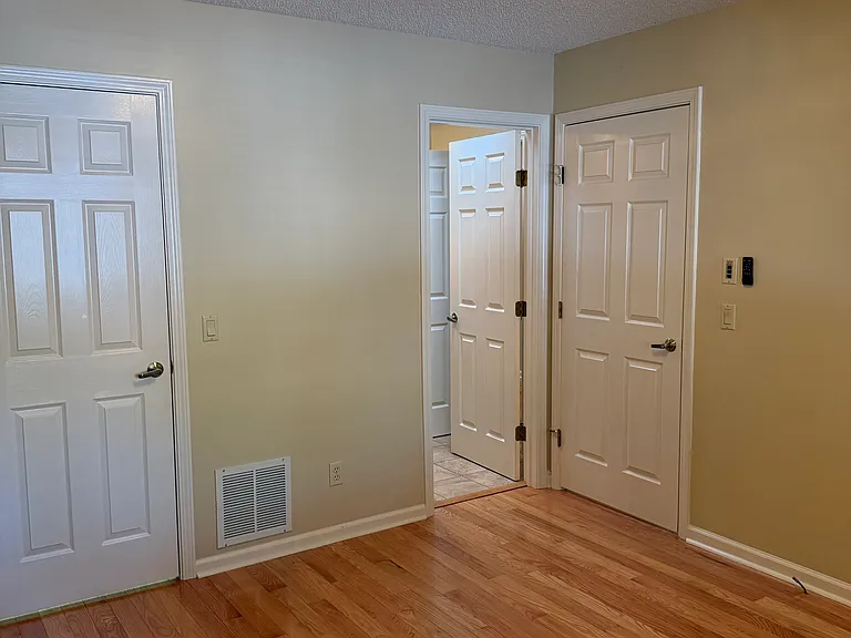 Front bedroom with new decorative fanlight, full bath and walk-in closet door to far left.