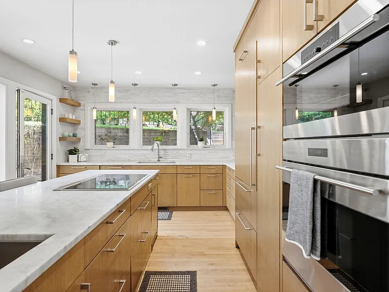 Spacious kitchen with lots of windows and patio entrance as well as adjacent dining room.