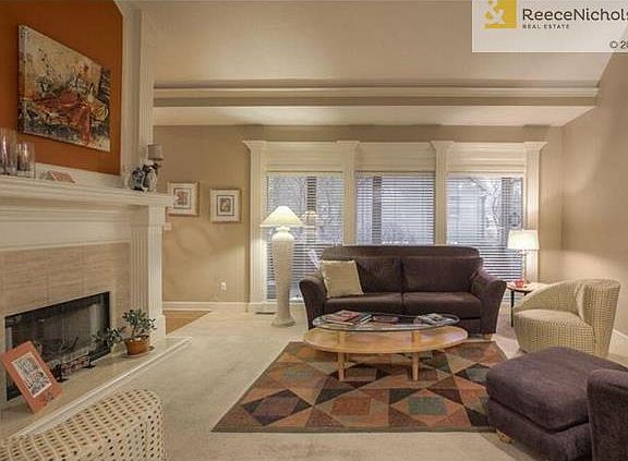 Family room shares a double-sided fireplace with the hearth kitchen.
