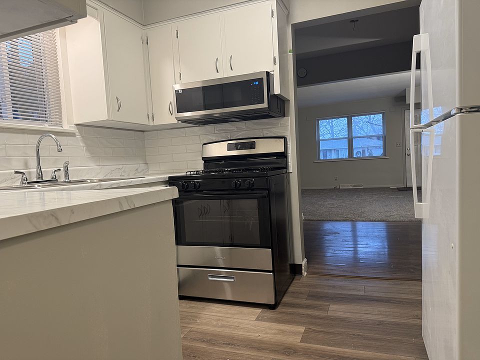 Remodeled kitchen with new microwave, gas stove and two year old refrigerator.