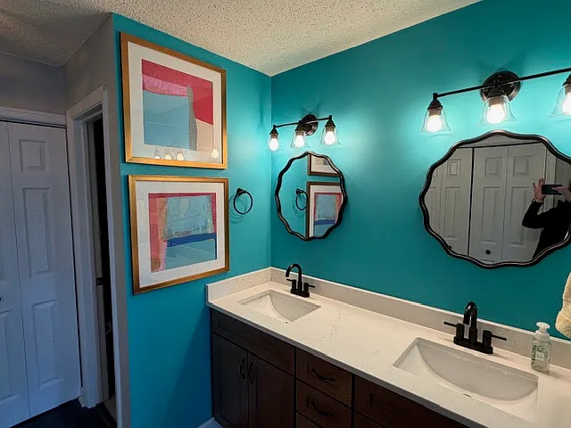 Primary bedroom offers private bath, double sinks...