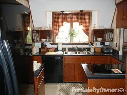 Basement
						:
						Half of basement showcasing built in bookshelfs, bar and entertainment area.