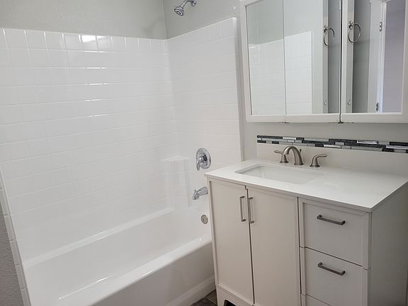 reglazed shower, new sink and cabinet, tile floor