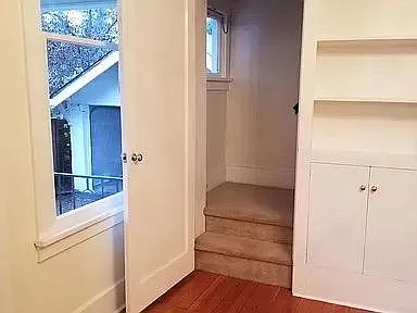 Stairs leading from dining room to 4 bedrooms and bathroom upstairs.