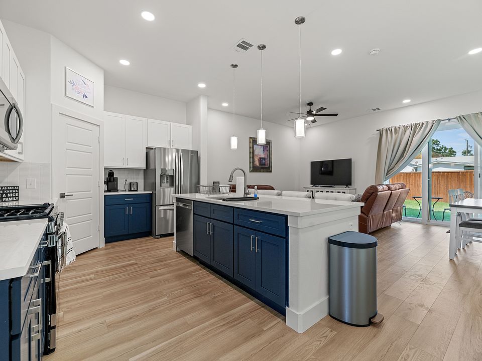 Open floor plan with a kitchen full of new high-end appliances.