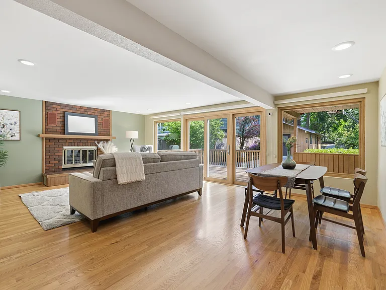 Spacious family room with brick fireplace and sliding doors to the deck