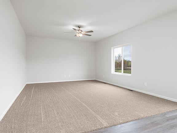 The family room is spacious with a ceiling fan.