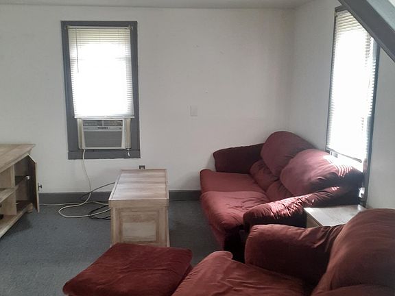 Living Room. View from the additional entry room. Furniture may be kept or can be removed to bring your own.