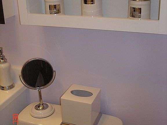 Extra vanity cabinet over tank