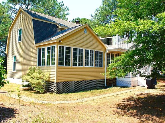 Back of home with porch and decking