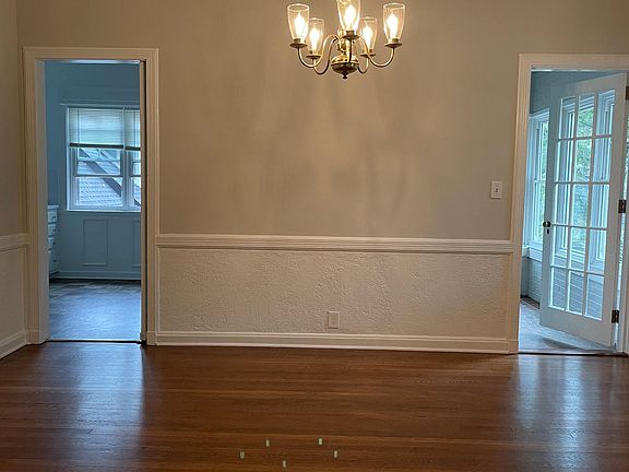 Dining room leading to eat in kitchen on left and sunroom on the right.