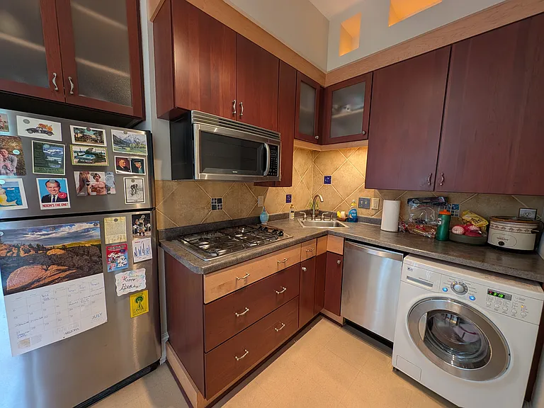 kitchen appliances: stove, washer/dryer, and dishwasher in unit
