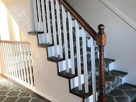 Stairs with carpet runner leading to 2nd floor