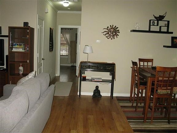 When you enter the front door there is a short entrance hallway that has a the entry to kitchen on right and door to garage on left. This is the view from the front door going into a living/dining combo room