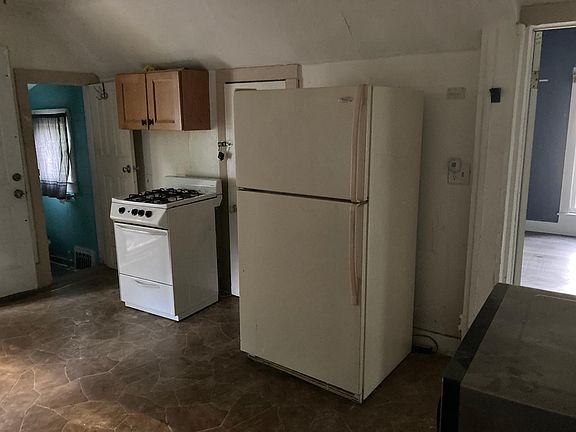 A view of the kitchen's stove and fridge