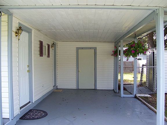 carport and inside utility room with sink