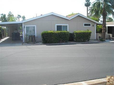 Full view w/ carport & shed.