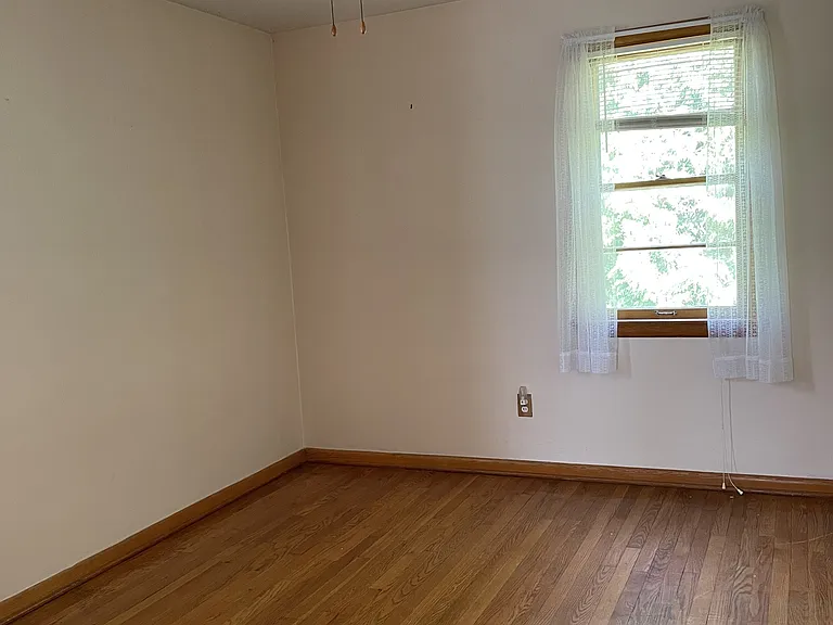 Medium bedroom has plenty of light from two windows
