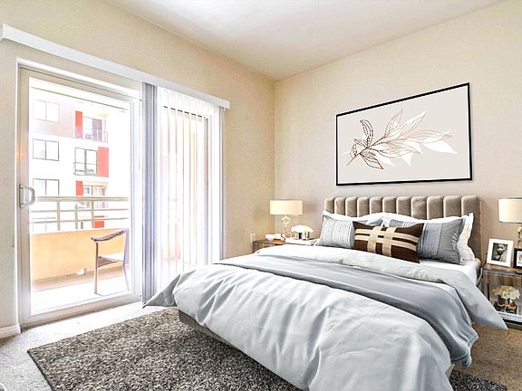 Primary Bedroom with view of Private Balcony - Virtually staged