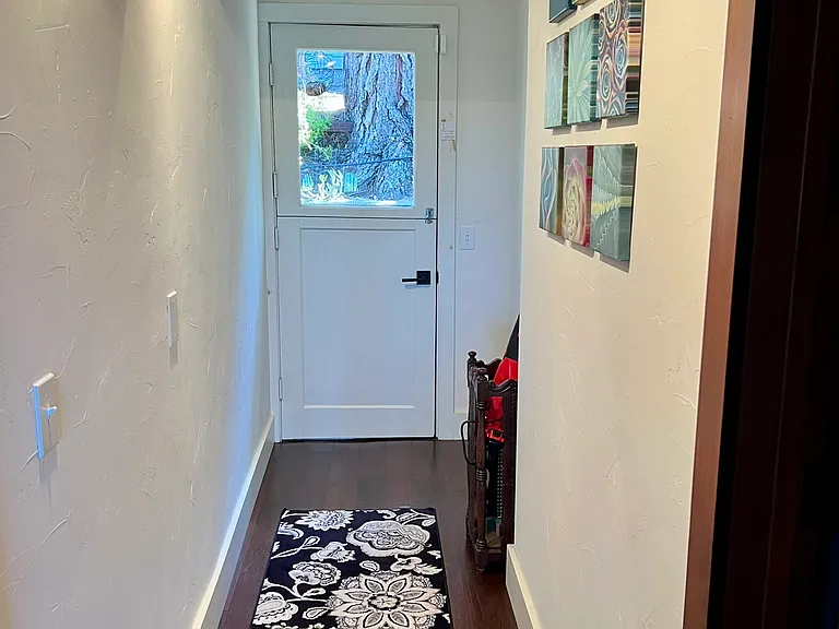 Looking down hall from kitchen to the dutch door leading to the back yard