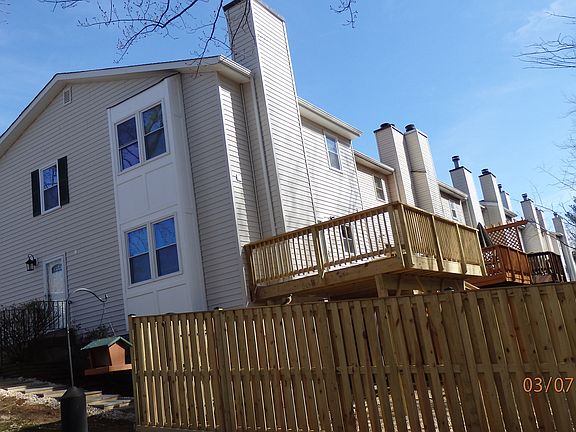 View from the back, showing full deck and fenced backyard
