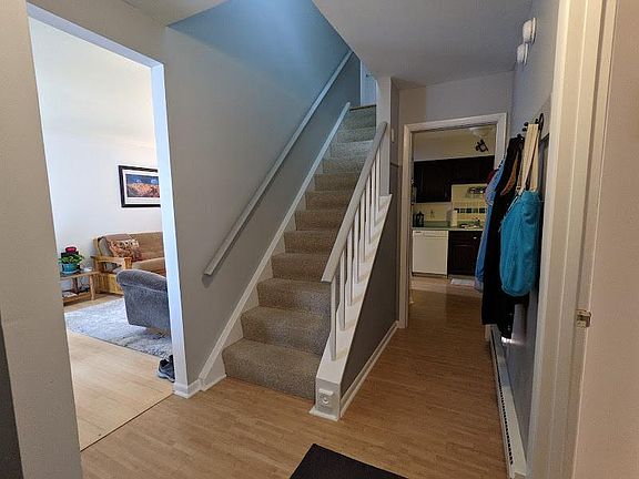 Stairs, living room, and kitchen seen from entrance