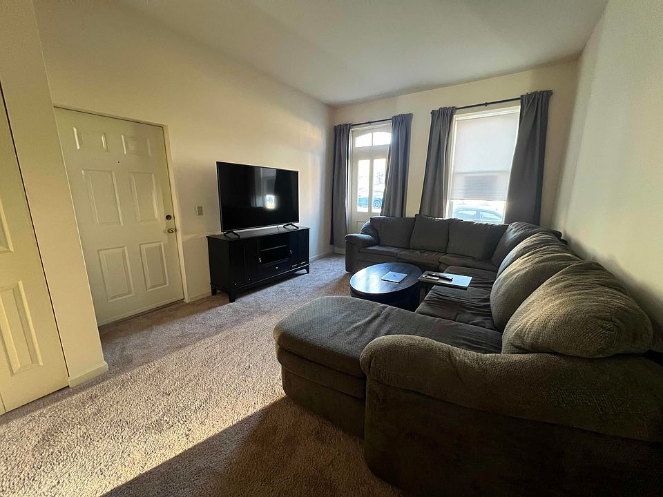Spacious living room with room with a large sectional and more.
