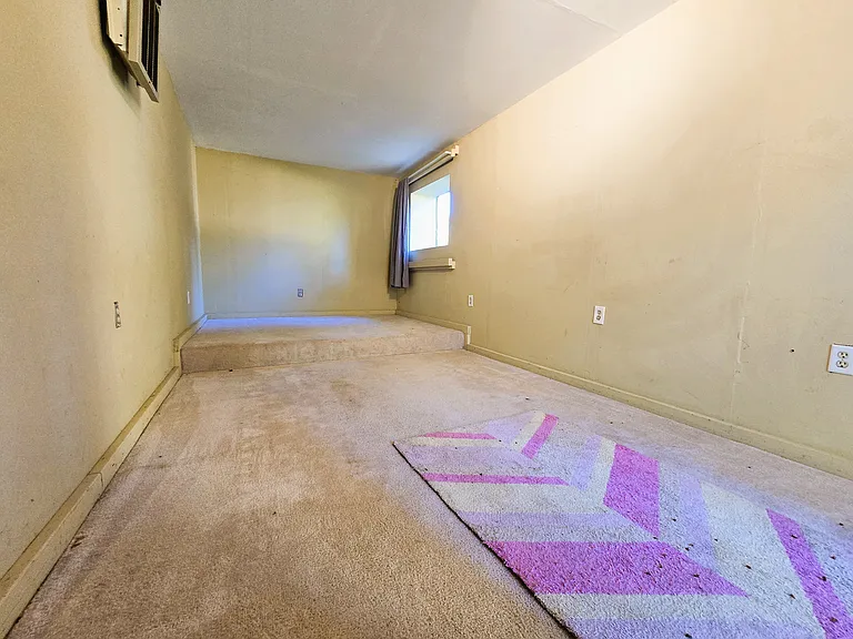 Carpeted, wired, with electric heater. Currently professionally cleaned and shampooed. You can sleep on it!