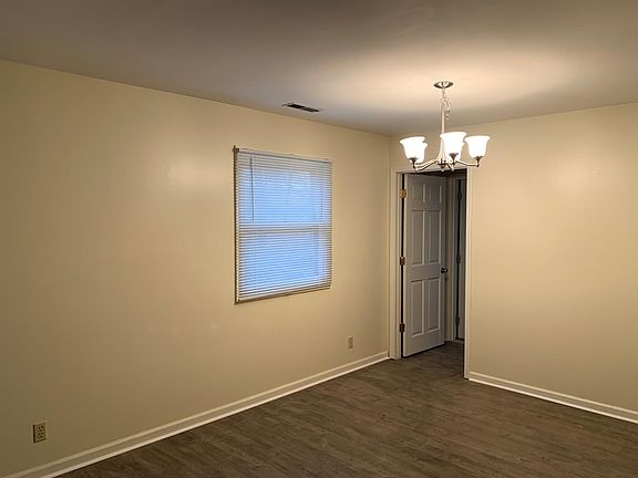 Dining room. Door way leads to staircase to second floor and utility room.