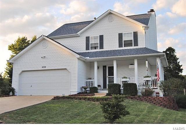 Front exterior with beautifully manicured lawn