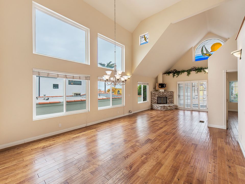 Bright and spacious with huge wall of windows, hardwood floors, balcony and soaring ceilings