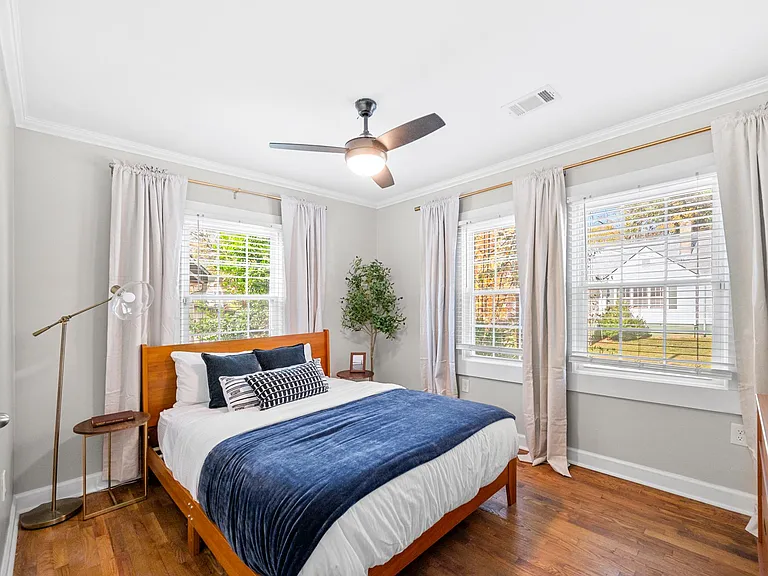 This room features a stylish dresser and a small closet, providing convenient storage solutions without compromising on aesthetics. Close the blackout curtains before jumping into the queen-sized bed for ultimate relaxation.