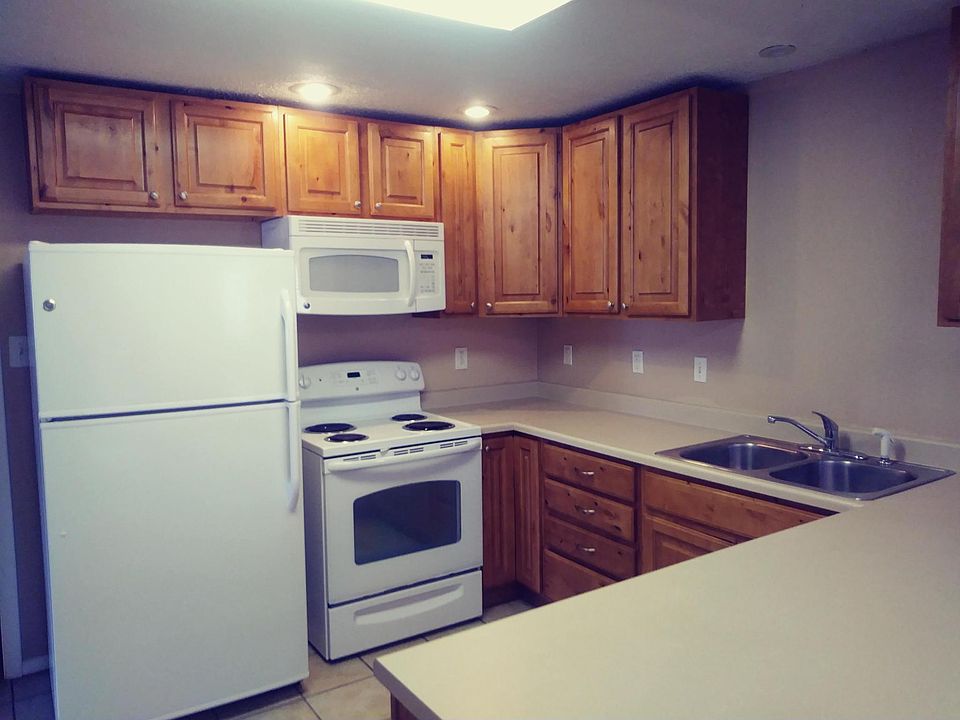 newert kitchen featuring wood cabinets, refrigerator, disposal, microwave, dishwasher and electric range