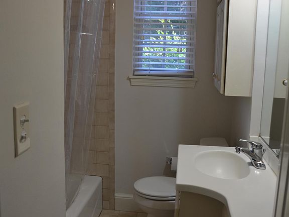 Bathroom with tub shower combo and plenty of built in storage