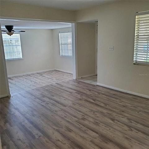 Living room and den with newly installed luxury plank flooring.